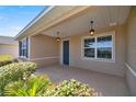Covered front porch with double doors and pendant lighting at 10145 Sw 89Th Loop, Ocala, FL 34481