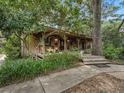 Charming wood home with a large porch surrounded by trees at 4344 Cr 542H, Bushnell, FL 33513