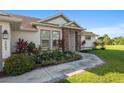 Landscaped front yard with walkway leading to a charming house entrance at 5005 Sw 106Th St, Ocala, FL 34476