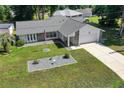 Single-story house with gray roof and landscaped front yard at 13027 Ne 7Th Loop, Silver Springs, FL 34488