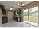 Modern kitchen with dark cabinets and sliding glass door at 247 Malauka Loop, Ocklawaha, FL 32179