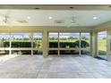 Spacious screened porch with tile flooring, ceiling fans and views of the golf course at 2003 Odessa Cir, The Villages, FL 32162