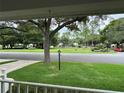 View from porch showing quiet street and green lawns at 8420 Sw 92Nd St # A, Ocala, FL 34481