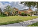 Single-story home with landscaped yard, palm trees, and a two-car garage at 9818 Sw 63Rd Loop, Ocala, FL 34481