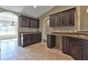 Dark wood kitchen cabinets with granite countertops at 7866 Sw 128Th Terrace Rd, Dunnellon, FL 34432