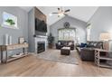 Open living room featuring a fireplace and vaulted ceiling at 728 Lake Diamond Ave, Ocala, FL 34472