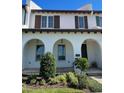 Two-story home with arched entryway and shutters at 8943 Lakeshore Pointe Drive, Winter Garden, FL 34787