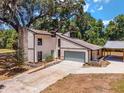 Two-story house with stone fireplace, attached garage, and landscaped yard at 14260 Ne 40Th Ct, Anthony, FL 32617