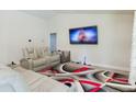 Relaxing home theater with plush seating and a large TV at 3962 Ne 58Th Cir, Silver Springs, FL 34488