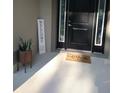 Inviting front entrance with a modern black door and a welcoming mat at 3962 Ne 58Th Cir, Silver Springs, FL 34488