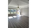 Spacious living room featuring light gray vinyl plank flooring and neutral walls at 73 Juniper Trail Loop, Ocala, FL 34480