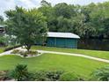 Private boat dock with a covered storage area and manicured lawn at 56633 Otter Rd, Astor, FL 32102