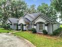 House exterior showcasing a long driveway and landscaping at 6615 Se 158Th Pl # 6, Summerfield, FL 34491