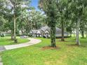 House exterior with a long driveway and green lawn at 6615 Se 158Th Pl # 6, Summerfield, FL 34491
