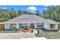 Newly renovated home with gray roof, white exterior, and a charming front porch at 495 Fisher Rd, Ocklawaha, FL 32179