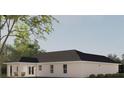 Rear view of house with covered patio, landscaping, and spacious backyard at Tbd Magnolia Place Dr, Ocklawaha, FL 32179