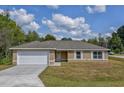 Newly built single-story home with a white garage door at 12789 Sw 86Th Cir, Ocala, FL 34473