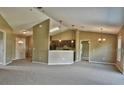 Open living room with kitchen, access to hallway and sliding door to backyard at 12789 Sw 86Th Cir, Ocala, FL 34473