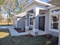 House exterior showcasing a front porch, landscaping, and walkway at 5508 Sw 108Th St, Ocala, FL 34476