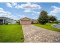 Single-story home with brick paver driveway and landscaped lawn at 16292 Sw 13Th Ter, Ocala, FL 34473