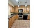 Kitchen with light wood cabinets, stainless steel appliances, and tile floors at 2851 Sw 32Nd Ave # 12, Ocala, FL 34474