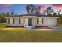 Cute single-story home with gray exterior, great curb appeal at 24449 Nw Falcon Ave, Dunnellon, FL 34431