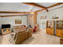Spacious living room with stone fireplace and high ceilings at 7679 S Magnolia Ave, Ocala, FL 34476