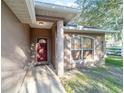 Front entrance of the house with a red door and stone accents at 2635 Ne 7Th St # 105, Ocala, FL 34470