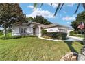 House exterior with lush green lawn and flag at 9500 Sw 93Rd Loop, Ocala, FL 34481
