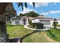 Home exterior showcasing manicured lawn and driveway at 9500 Sw 93Rd Loop, Ocala, FL 34481