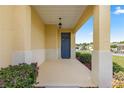 Inviting front porch with blue door and landscaping at 9818 Sw 99Th Loop, Ocala, FL 34481