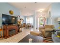 Bright living room featuring tile floors, fireplace, and access to dining area at 8655 Sw 86Th Cir, Ocala, FL 34481
