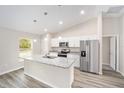 Modern kitchen with stainless steel appliances and granite countertops at 304 Locust Pass, Ocala, FL 34472