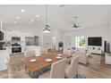 Modern kitchen with white cabinets and island, open to living area at 5 Emerald Trl, Ocala, FL 34472