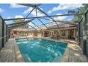 Large, screened-in pool with patio furniture at 1133 Se 24Th Ter, Ocala, FL 34471