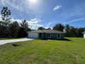 Newly constructed home with a single car garage and spacious lawn at 46 Fisher Ter, Ocklawaha, FL 32179