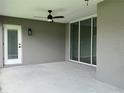 Covered patio with sliding glass doors and ceiling fan at 7530 Sw 100Th St, Ocala, FL 34476