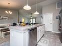Modern kitchen with island, stainless steel appliances, and white cabinets at 1436 Ne 161St Pl, Citra, FL 32113