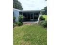 Side view of a screened porch with a paved patio at 10886 Sw 87Th Ct, Ocala, FL 34481