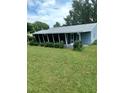 Spacious screened-in porch with lush green lawn at 10886 Sw 87Th Ct, Ocala, FL 34481