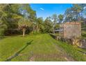 Ranch-style home with a stone wall and arbor at 23401 Ne 113Th Ave, Fort Mc Coy, FL 32134