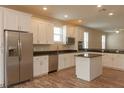 Kitchen island, stainless steel appliances, and hardwood floors at 0 Fisher Lane Way, Ocklawaha, FL 32179