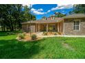 House exterior with stone facade and landscaped yard at 1989 Nw 111Th Loop, Ocala, FL 34475