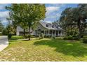 Two-story home with wraparound porch and large backyard at 7545 Ne 58Th Ave, Anthony, FL 32617