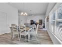 Bright dining area with table and chairs, open to the living room at 1789 Usrey Ct, The Villages, FL 34762