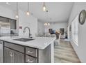 Modern kitchen island with white countertops and gray cabinets at 1789 Usrey Ct, The Villages, FL 34762