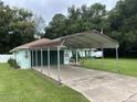 Light green house with carport and well-maintained lawn at 6690 Cherry Rd, Ocala, FL 34472