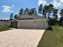 Two-story house with a three car garage and landscaped yard at 7088 Sw 179Th Court Rd, Dunnellon, FL 34432