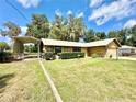 Charming home showcasing a carport and lush green lawn at 26 Juniper Pass Ln, Ocala, FL 34480
