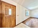 Inviting entryway with hardwood floors and a wood door with glass accents at 26 Juniper Pass Ln, Ocala, FL 34480